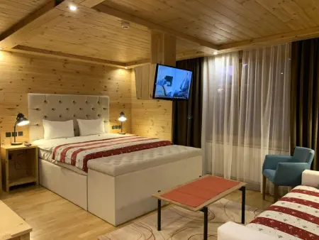 Die Ski-Suite hat ein Schlafzimmer und ein kleines Wohnzimmer ohne Küche. - Photo 45